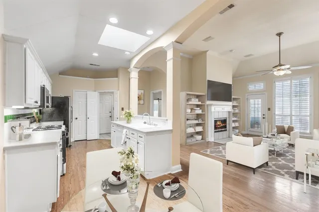 a living room with kitchen island furniture and a flat screen tv