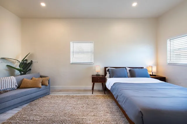 a bedroom with a bed and a couch