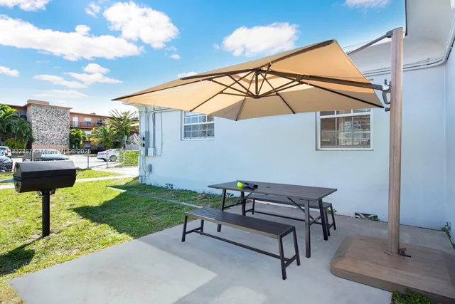 a view of a backyard with sitting area