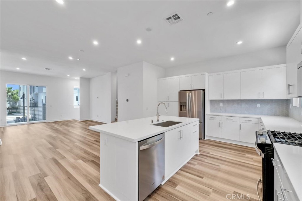 1122 West Bushell Street Anaheim, CA 92805 - Photo 11 of 17 a kitchen with a sink stove and refrigerator