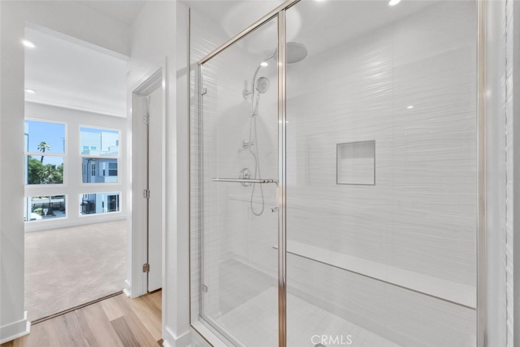 1122 West Bushell Street Anaheim, CA 92805 - Photo 14 of 17 a bathroom with a glass shower door