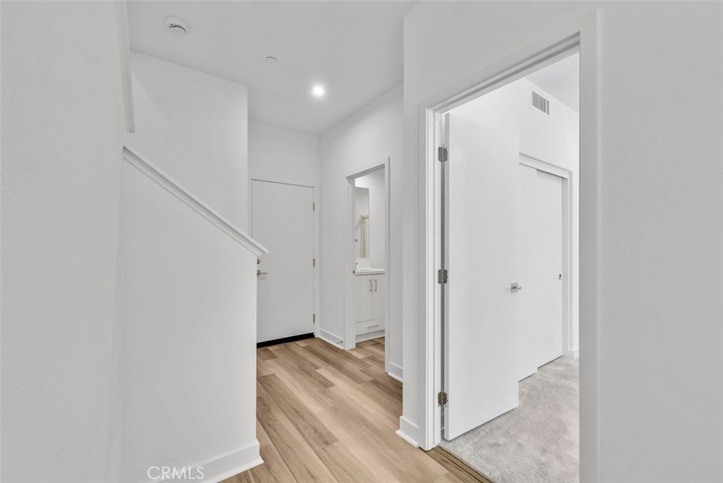 1122 West Bushell Street Anaheim, CA 92805 - Photo 4 of 17 a view of a hallway with wooden floor and entryway