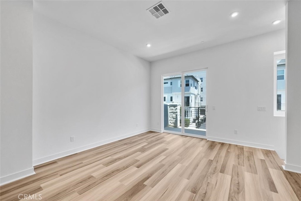 1122 West Bushell Street Anaheim, CA 92805 - Photo 7 of 17 a view of an empty room with wooden floor and a window