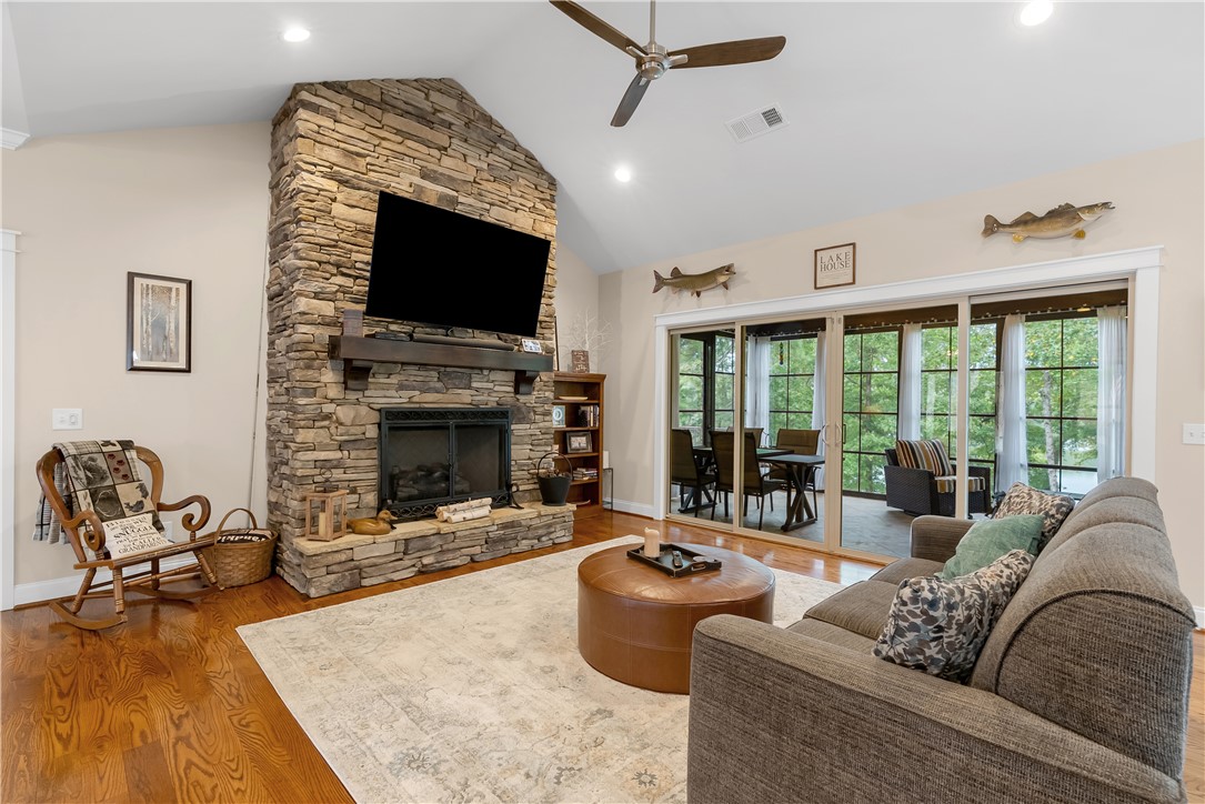 329 High Hampton Road Salem, SC 29676 - Photo 7 of 47 A stone fireplace accents the living space under vaulted ceilings and rich wood floors.