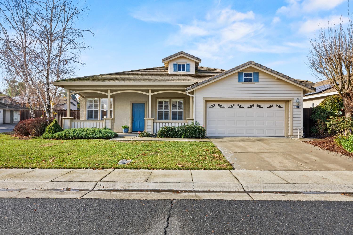 2305 Leonardo Street Davis, CA 95618 - Photo 1 of 1 a front view of a house with a yard and garage