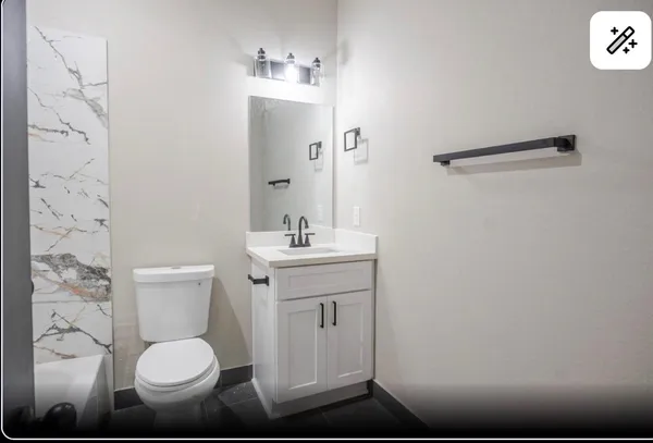 a bathroom with a toilet sink and mirror
