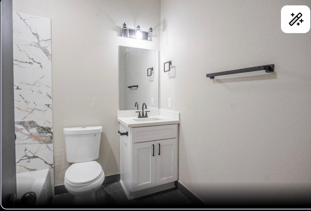 8713 Westcott Road, Unit B Houston, TX 77016 - Photo 12 of 14 a bathroom with a toilet sink and mirror