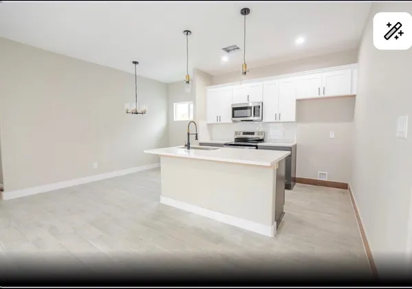 a kitchen with stainless steel appliances granite countertop a sink a stove and a refrigerator