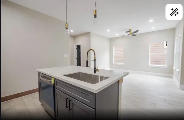 a kitchen with a sink and chandelier