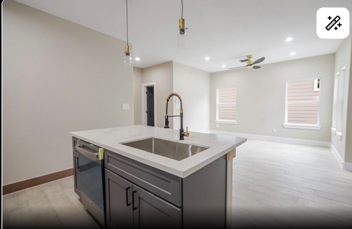 8713 Westcott Road, Unit B Houston, TX 77016 - Photo 5 of 14 a kitchen with a sink and chandelier