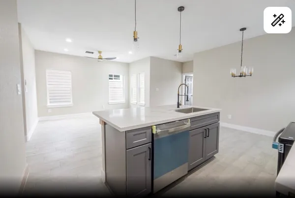 a kitchen with stainless steel appliances granite countertop a sink a stove and a wooden floor