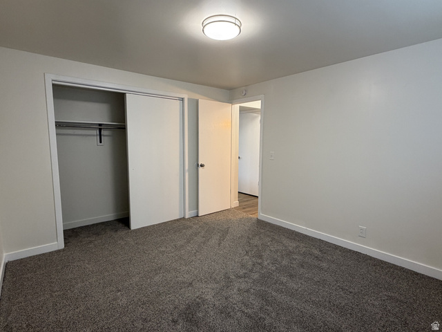 895 East Arrowhead Lane Murray, UT 84107 - Photo 9 of 12 Neutral tone wall paint, flush mount ceiling light, and plush grey carpet flooring