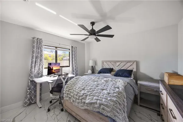 a bedroom with a bed and window