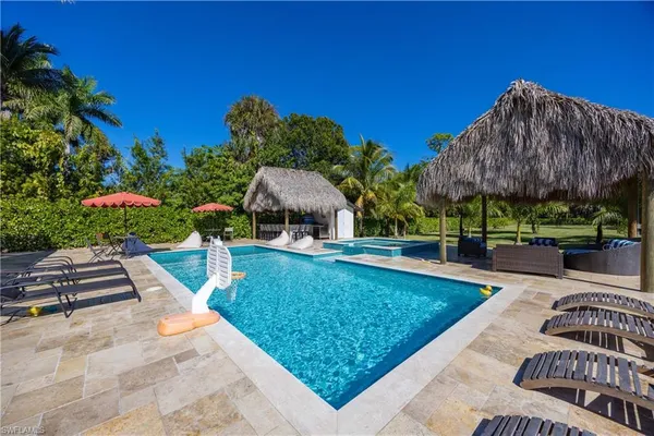 a view of a swimming pool and sitting area