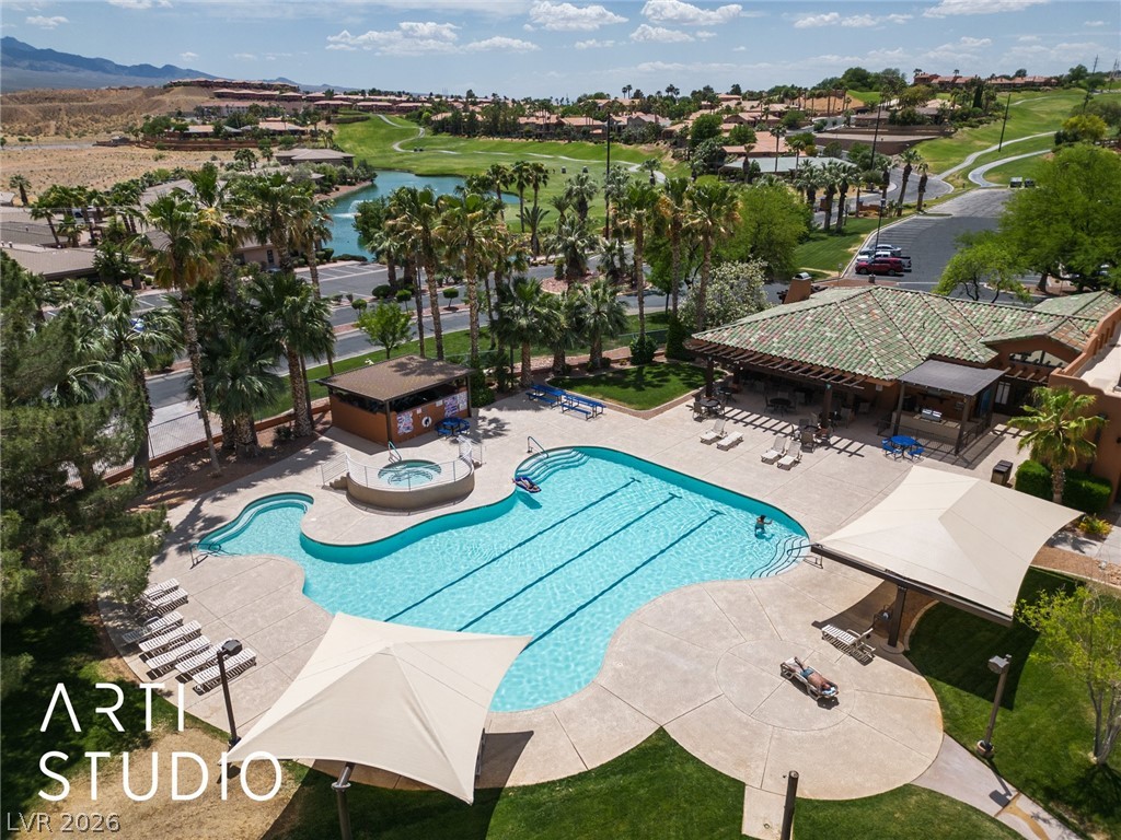 387 Silver Road Mesquite, NV 89027 - Photo 41 of 46 An inviting community swimming pool overlooks a lush golf course under open skies.