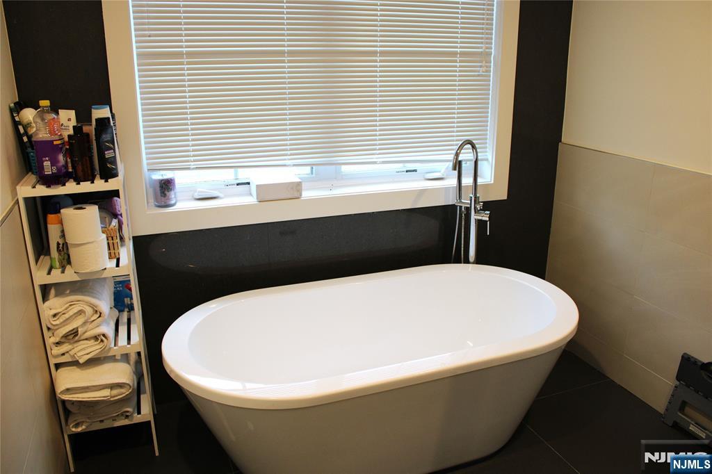 294-296 Tenafly Road Tenafly, NJ 07670 - Photo 20 of 24 a white bath tub sitting in a bathroom next to a window