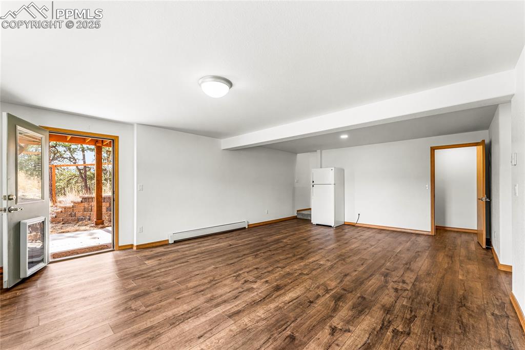 2649 Southpark Road Florissant, CO 80816 - Photo 19 of 42 wooden floor in an empty room with a window