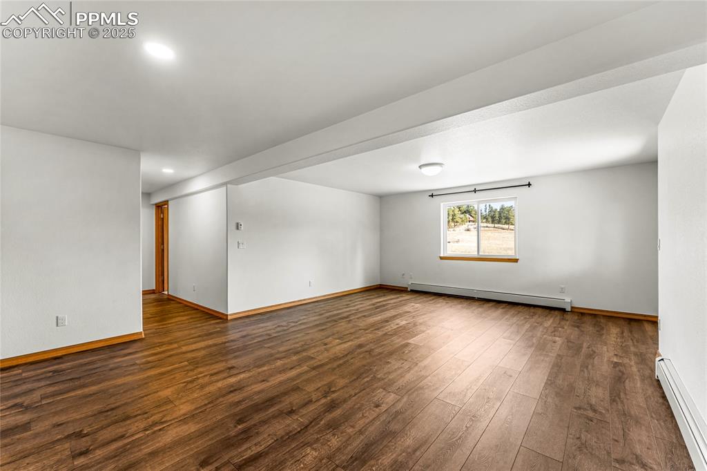 2649 Southpark Road Florissant, CO 80816 - Photo 20 of 42 an empty room with wooden floor and windows