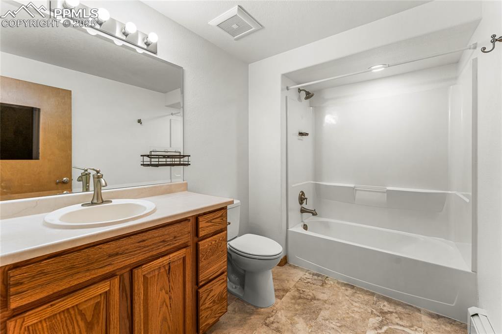 2649 Southpark Road Florissant, CO 80816 - Photo 25 of 42 a bathroom with a sink a toilet and a large mirror