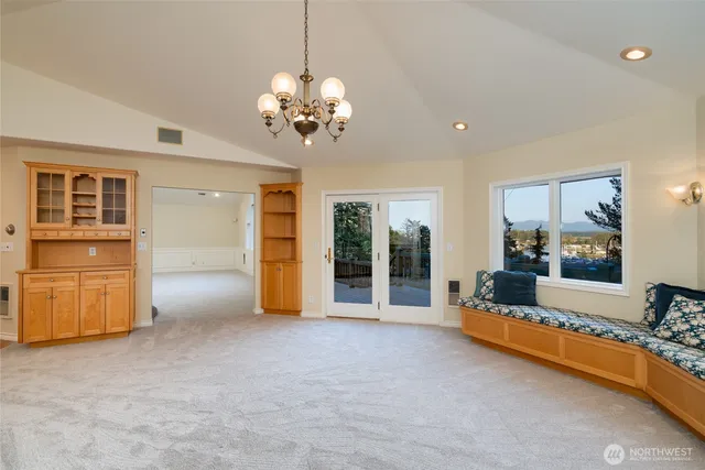 a view of a livingroom with furniture cabinet and chandelier