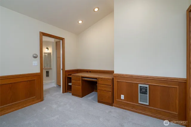 a view of an empty room with cabinet and stairs