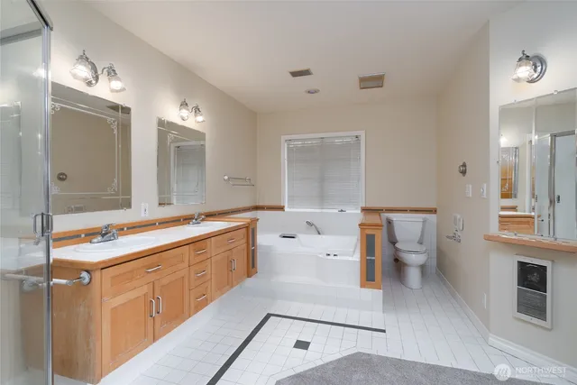 a spacious bathroom with a tub sink and mirror