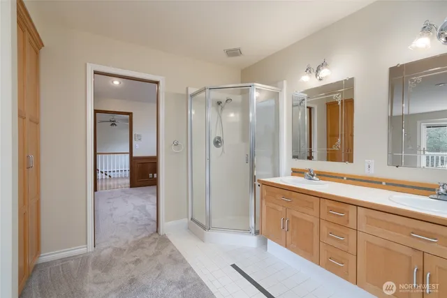 a spacious bathroom with a shower sink and mirror
