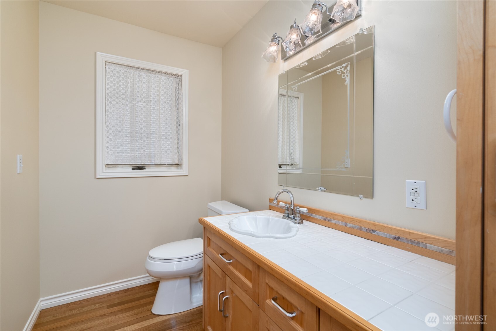 476 Nez Perce Place La Conner, WA 98257 - Photo 22 of 40 a bathroom with a toilet sink vanity and mirror