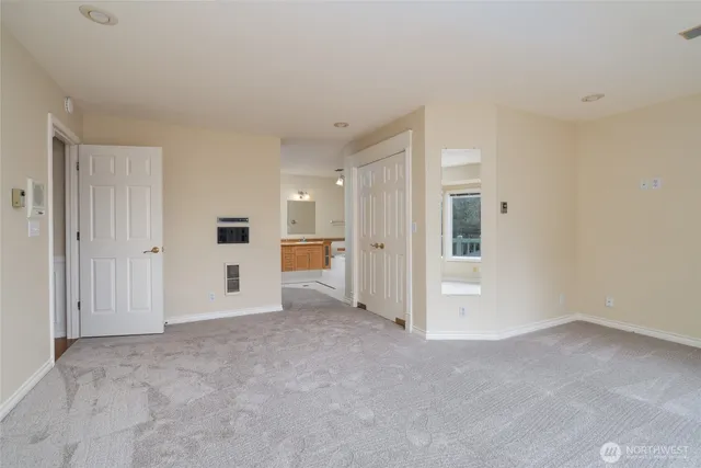 a large kitchen with stainless steel appliances kitchen island granite countertop a refrigerator and a stove top oven