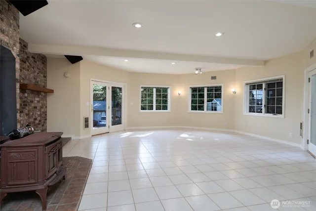 a view of an empty room with window and cabinet