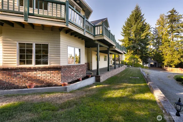 a backyard of a house with plants and outdoor seating