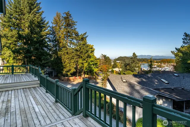 a view of backyard with deck and outdoor seating