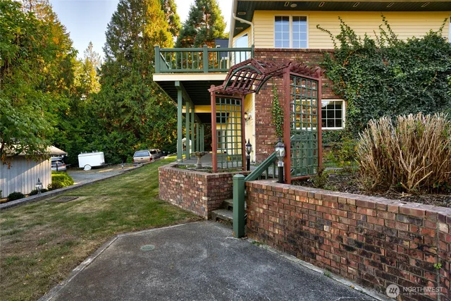 a view of house with a yard and sitting area