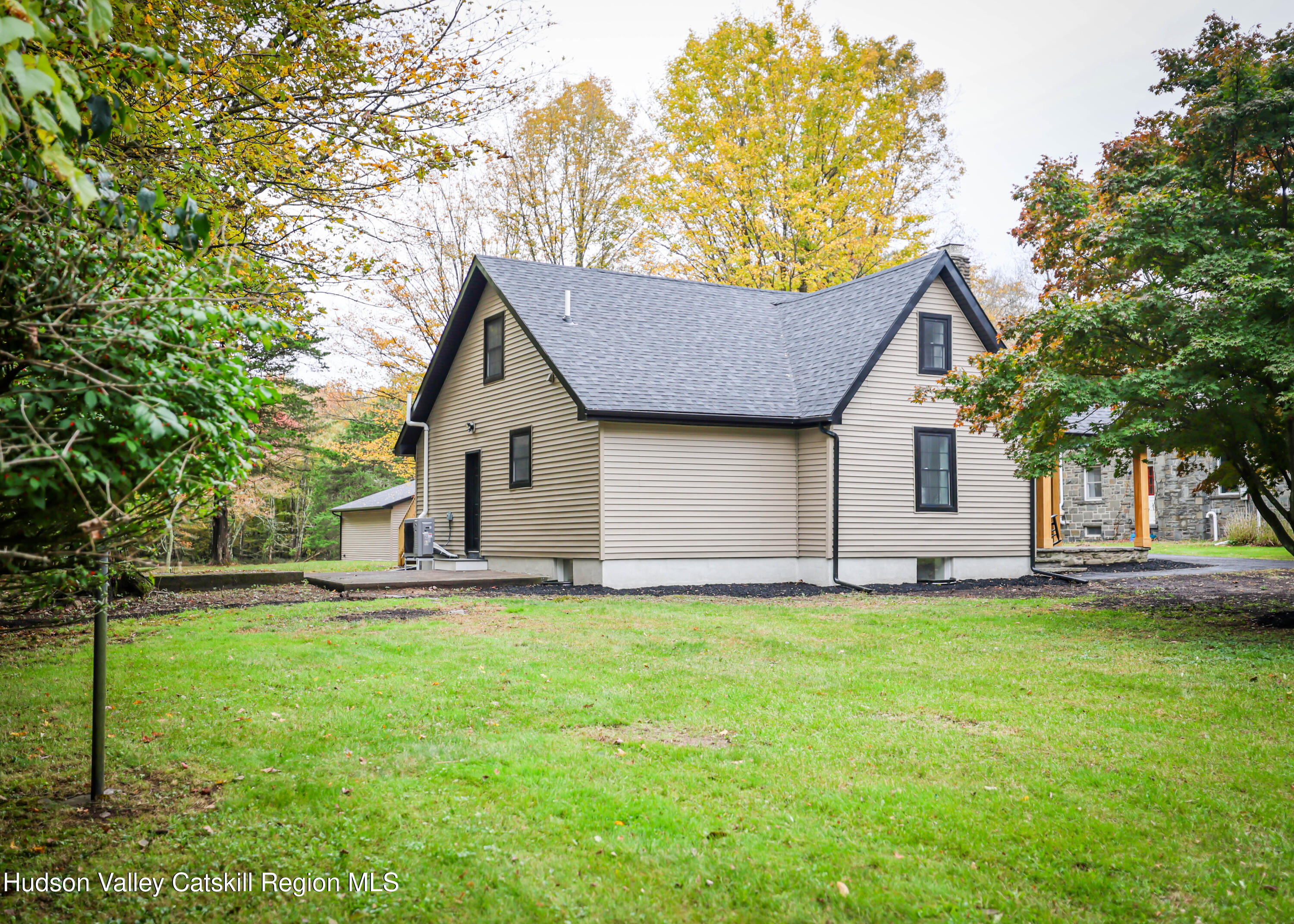 169 West Saugerties Road Saugerties, NY 12477 - Photo 12 of 43 a front view of a house with a garden and trees