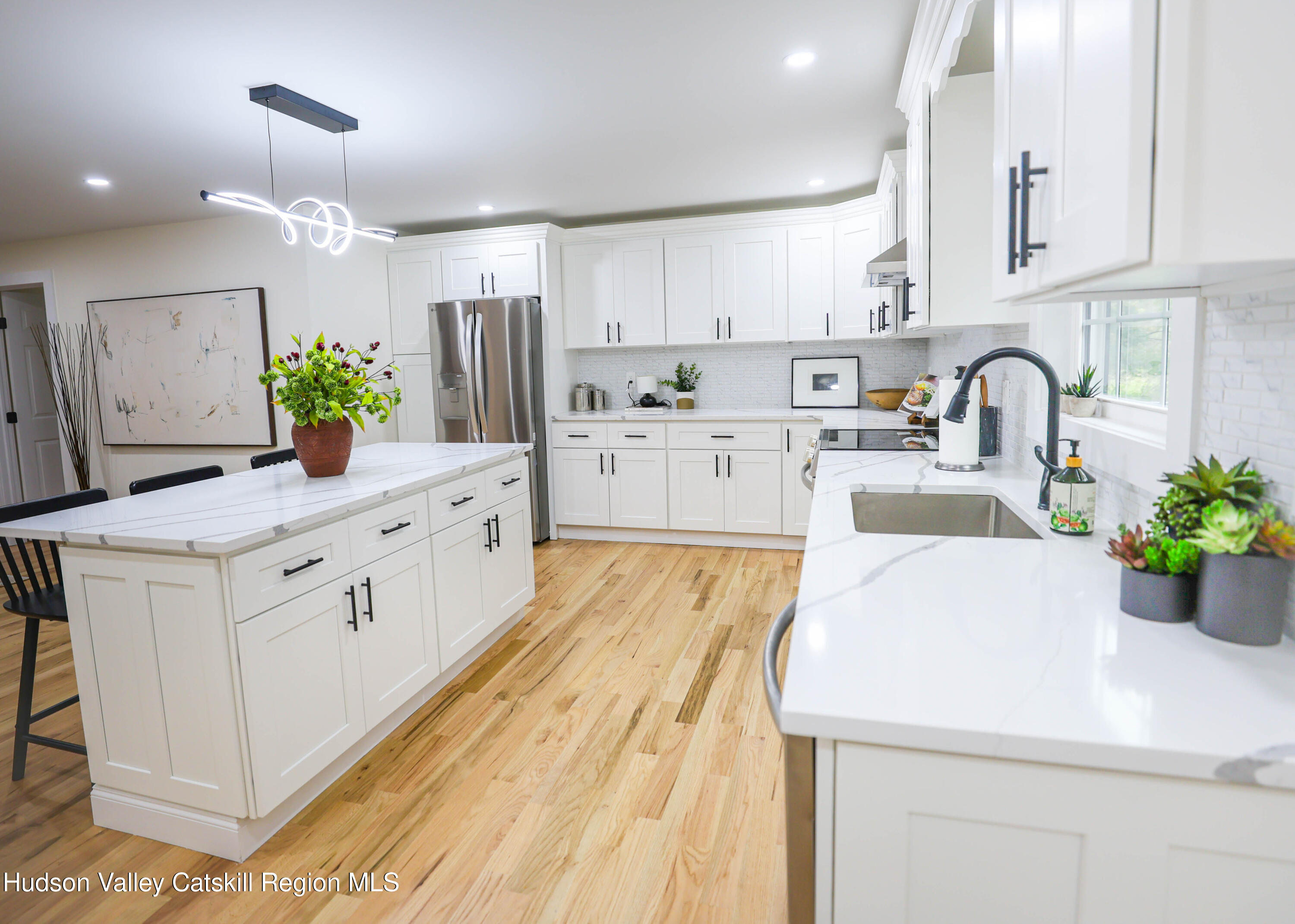 169 West Saugerties Road Saugerties, NY 12477 - Photo 16 of 43 a kitchen with white cabinets and center island