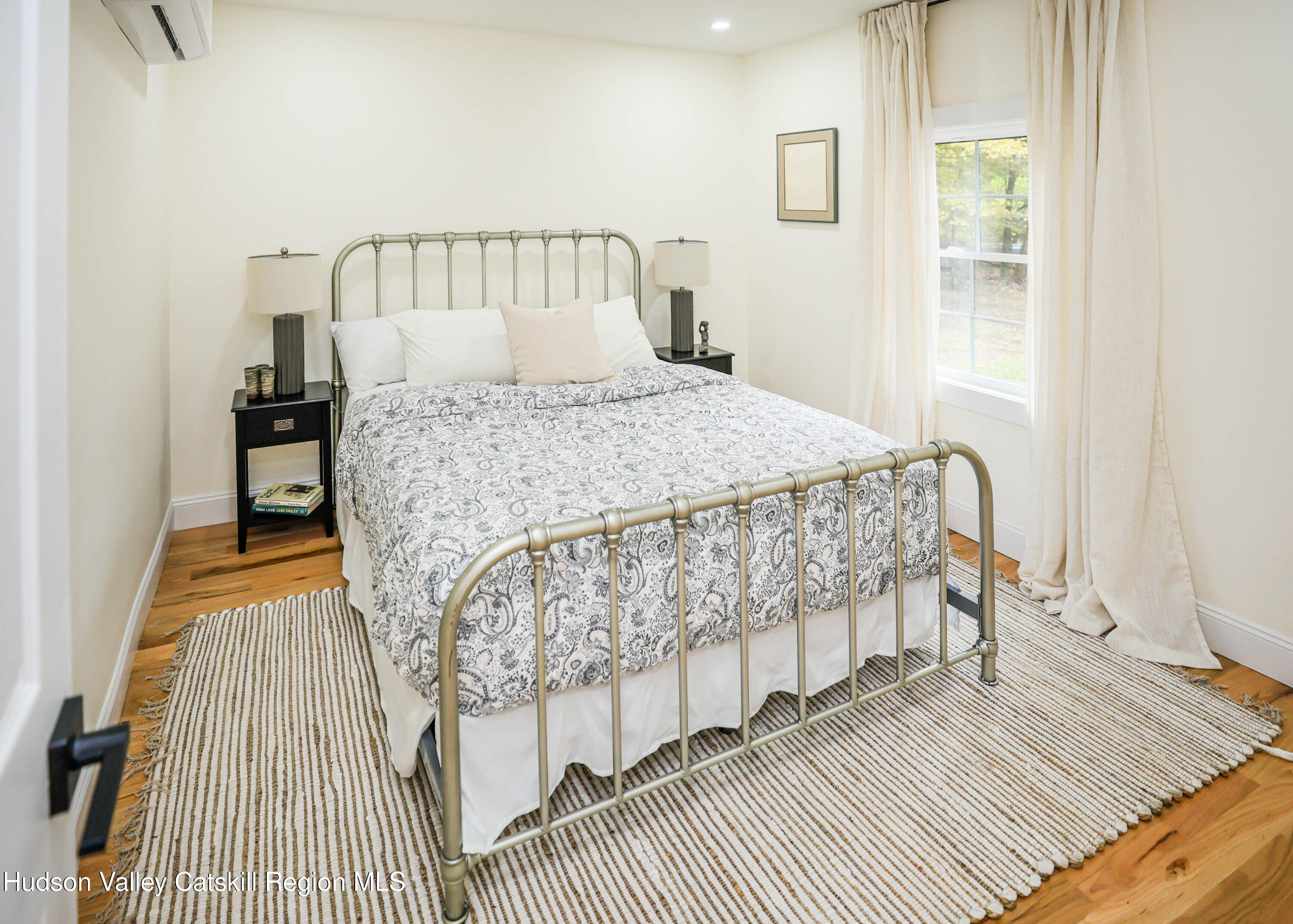 169 West Saugerties Road Saugerties, NY 12477 - Photo 10 of 43 a bed sitting in a bedroom next to a window with a balcony