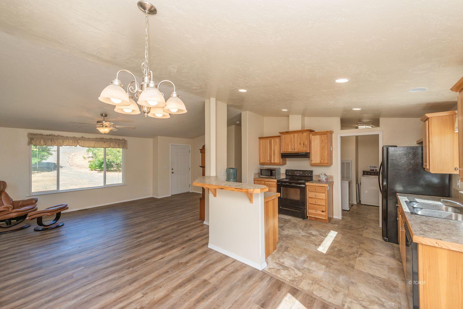 38500 Highway 299 Junction City, CA 96048 - Photo 14 of 49 a view of a kitchen with refrigerator microwave and stove