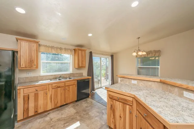 a large kitchen with kitchen island a sink stainless steel appliances and cabinets