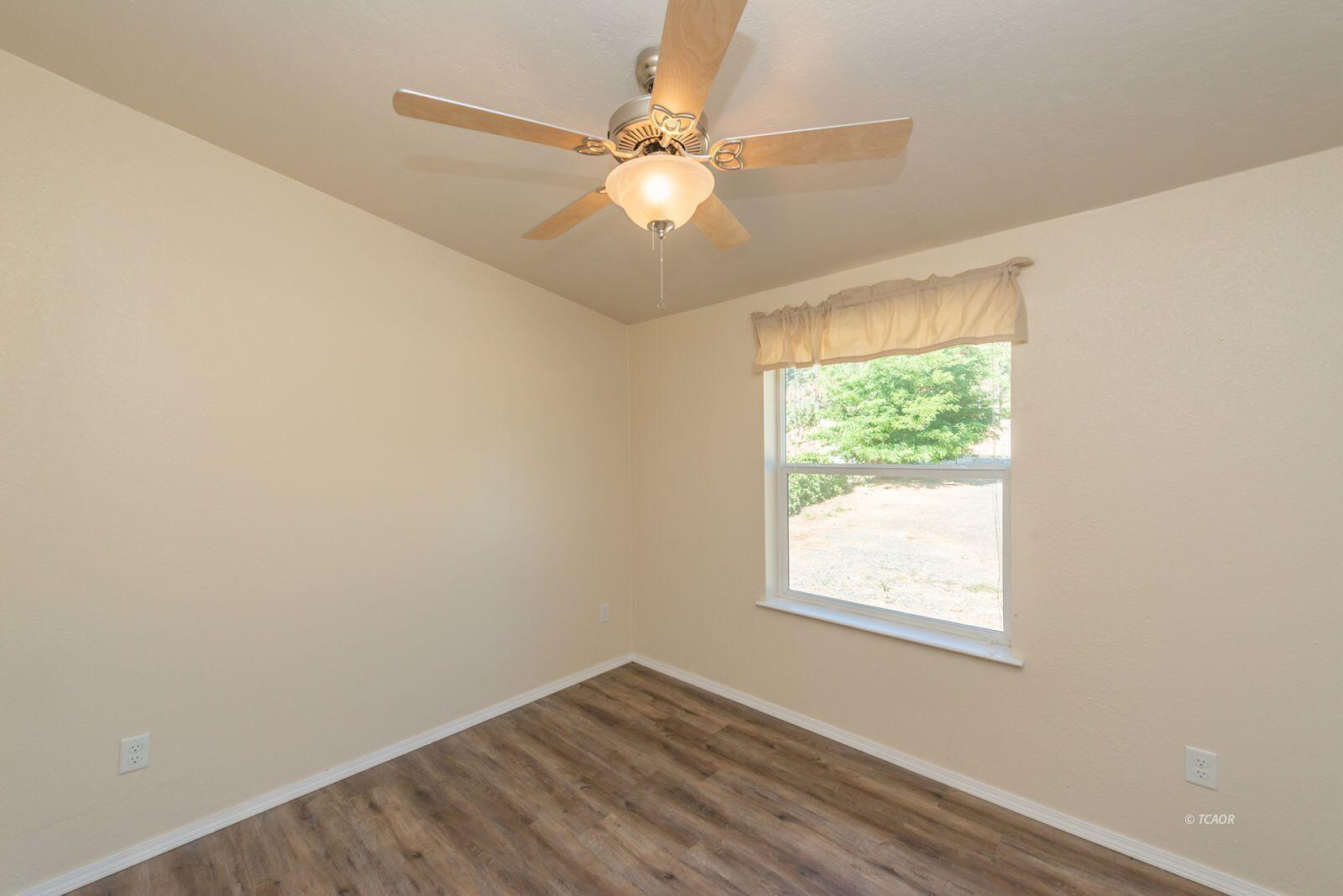 38500 Highway 299 Junction City, CA 96048 - Photo 24 of 49 an empty room with a window and a fan