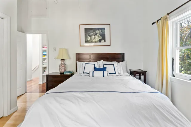 a bedroom with a bed and a painting on the wall