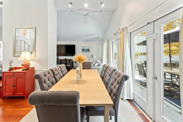 a living room with furniture dining table and a large window