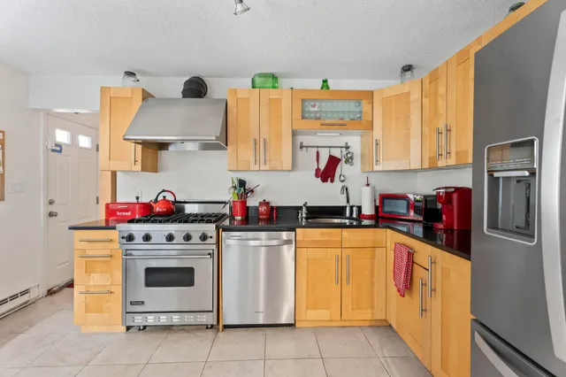 a kitchen with stainless steel appliances and white cabinets