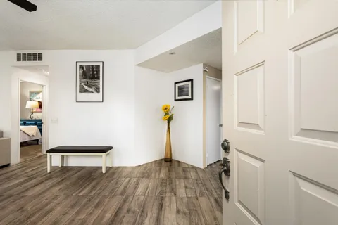 a hallway with wooden floor and furniture