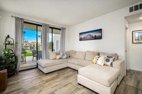 a living room with furniture and a large window