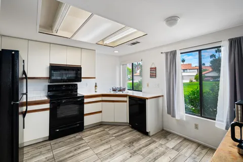a kitchen with stainless steel appliances granite countertop a stove and a refrigerator