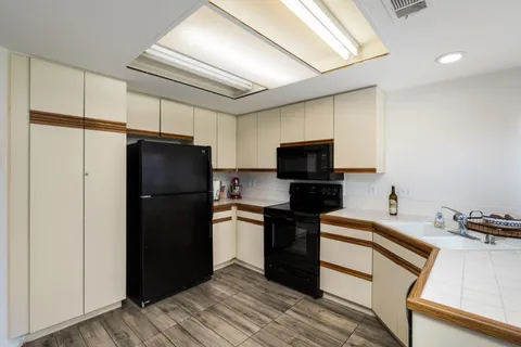 a kitchen with a refrigerator and a stove top oven