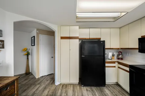 a kitchen with a refrigerator and a stove top oven
