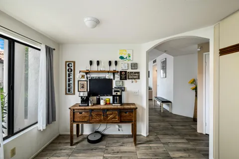 a view of a workspace with furniture and wooden floor