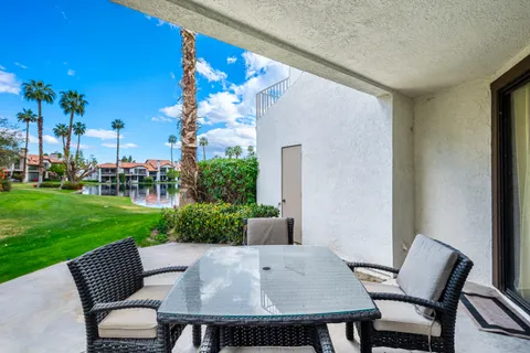 a view of a patio with a table and chairs