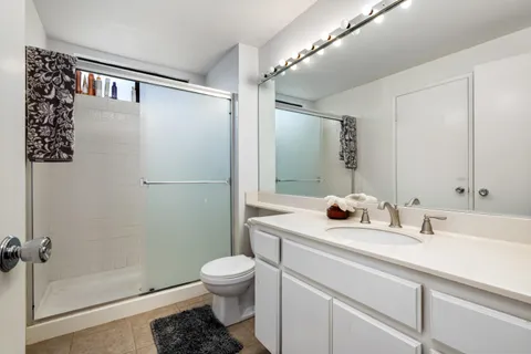 a bathroom with a sink toilet and shower